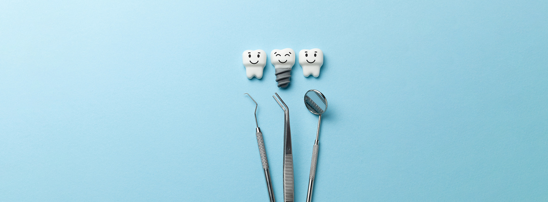 The image shows a collection of dental tools, including a toothbrush and dental floss, arranged in an artistic manner against a blue background.