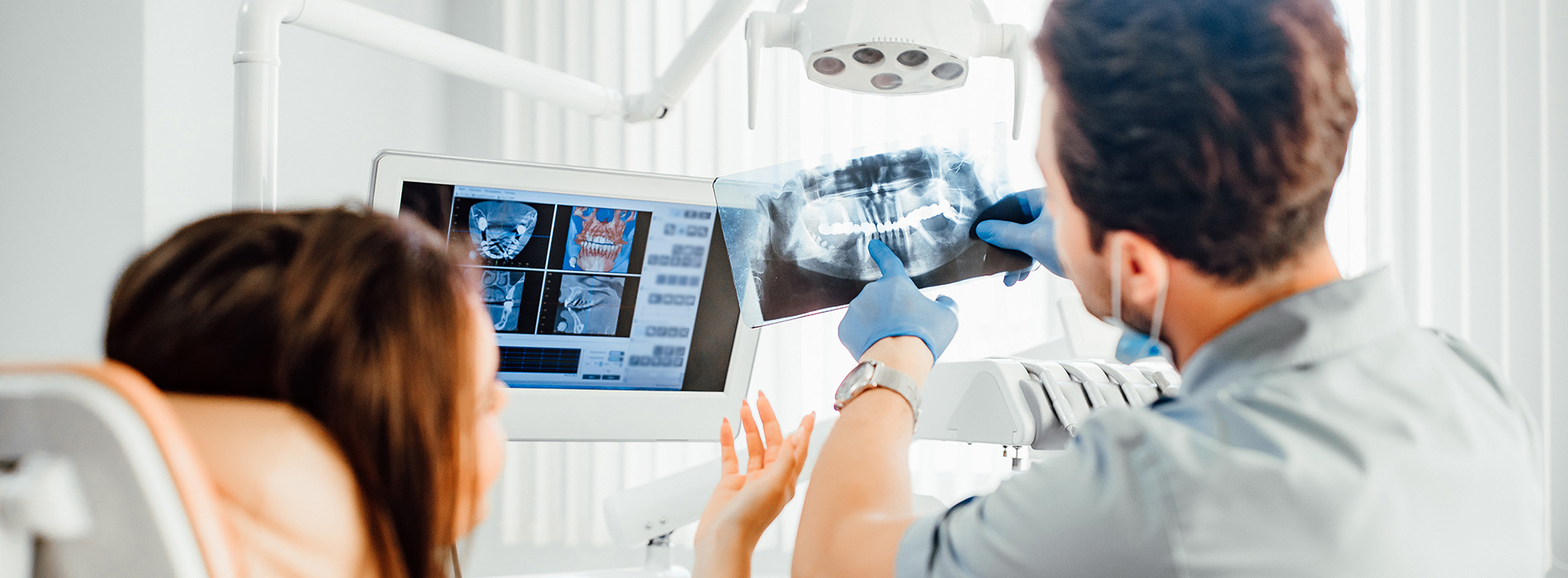 A man and woman in a medical setting, with an ultrasound machine on display.