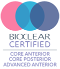The image is a digital graphic featuring a logo with three interconnected circles in blue, pink, and purple. Within the central circle, there s a stylized depiction of a globe in white, surrounded by a ring that contains text, including  DOLLAR CERTIFIED  and other smaller texts. The background is a gradient of light to dark gray, and at the bottom right corner, there is a black-and-white icon with an asterisk and the number 12, indicating some form of certification or accreditation status.