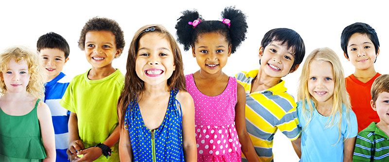 A group of diverse children and adults, all smiling and posing for a photo.